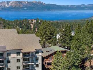 Experience breathtaking lake and mountain views from this stunning property, nestled amidst a lush pine forest.