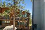 Experience breathtaking mountain views from this stunning wooden home, featuring multiple levels of expansive decks perfect for outdoor entertaining.