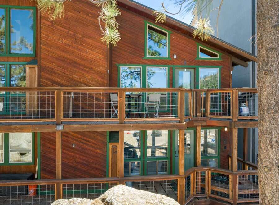 Experience mountain living in this charming wooden home featuring multiple levels of decks perfect for enjoying the crisp air and scenic views.