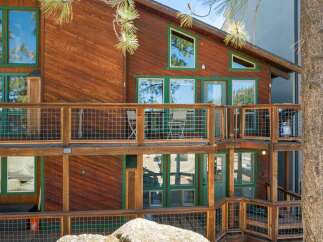 Experience mountain living in this charming wooden home featuring multiple levels of decks perfect for enjoying the crisp air and scenic views.