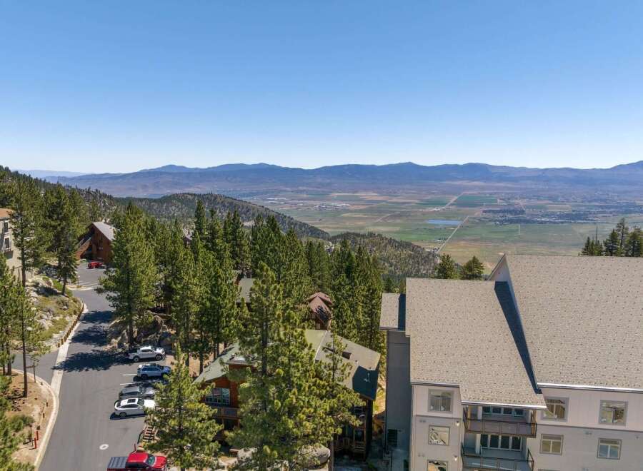 Experience breathtaking panoramic views from this stunning mountain property, nestled amidst towering pine trees.