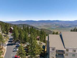 Experience breathtaking panoramic views from this stunning mountain property, nestled amidst towering pine trees.