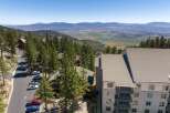 Experience breathtaking mountain views from this stunning property, nestled amidst tall pine trees.