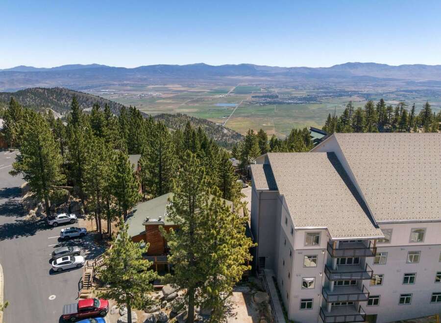 Experience breathtaking panoramic views from this stunning property nestled amidst towering pine trees.