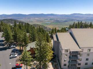Experience breathtaking panoramic views from this stunning property nestled amidst towering pine trees.