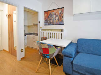 This charming studio apartment features a compact, well-equipped kitchen perfect for preparing meals.