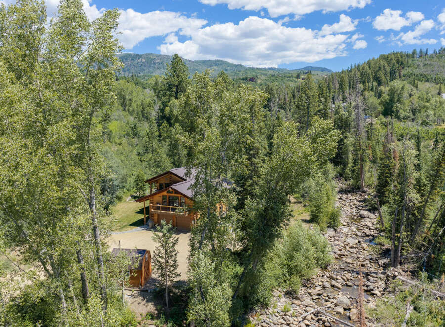 Nestled amidst a lush forest, this charming log home offers a serene mountain retreat.