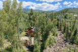Nestled amidst a lush forest, this charming log home offers a serene mountain retreat.
