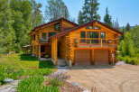 Experience rustic luxury in this stunning log home, nestled amidst lush greenery and mature trees.