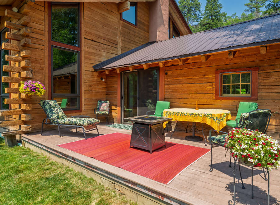 Enjoy outdoor living on this spacious wooden deck, perfect for entertaining or relaxing.