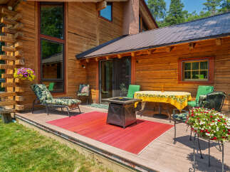 Enjoy outdoor living on this spacious wooden deck, perfect for entertaining or relaxing.