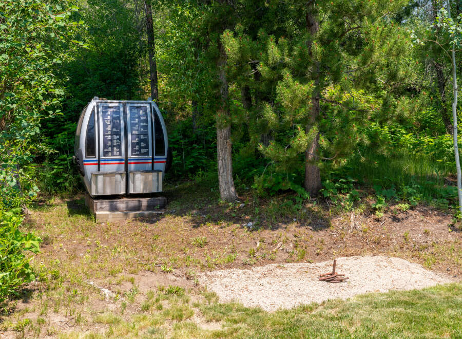Discover a unique property featuring a vintage ski lift gondola, offering a nostalgic touch to your outdoor space.