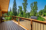 Enjoy the serene mountain views from this charming log cabin's spacious deck.