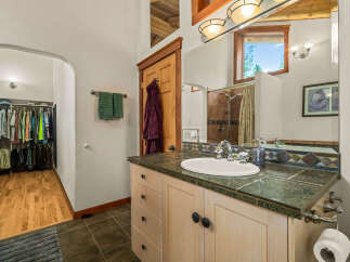 This charming bathroom features a spacious walk-in closet with ample storage for all your clothing needs.