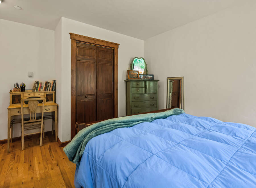 This charming bedroom features a cozy bed with a vibrant blue comforter, perfect for relaxation.