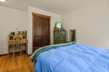 This charming bedroom features a cozy bed with a vibrant blue comforter, perfect for relaxation.