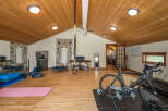 Transform your fitness routine in this dedicated home gym, featuring a professional cycling setup with a Cervelo bike on a trainer.