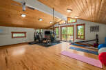 Transform your wellness routine in this spacious home gym, featuring a treadmill, elliptical, and stationary bike.