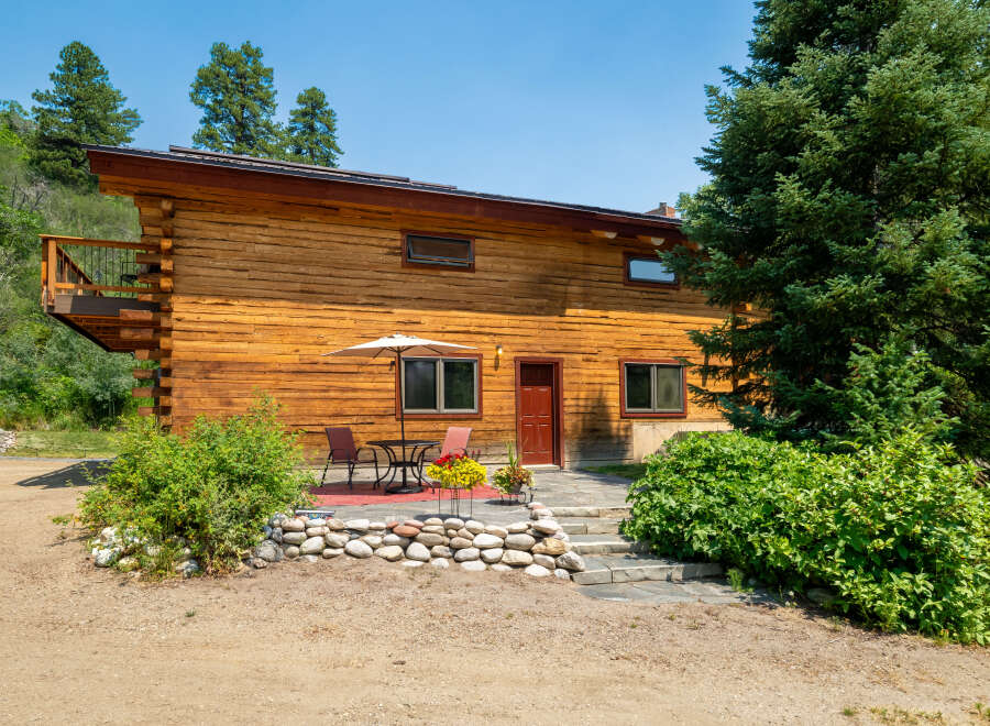 Experience rustic charm in this beautiful log home, nestled amidst lush greenery and mature trees.