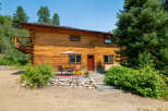 Experience rustic charm in this beautiful log home, nestled amidst lush greenery and mature trees.