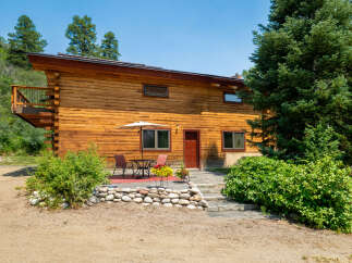 Experience rustic charm in this beautiful log home, nestled amidst lush greenery and mature trees.