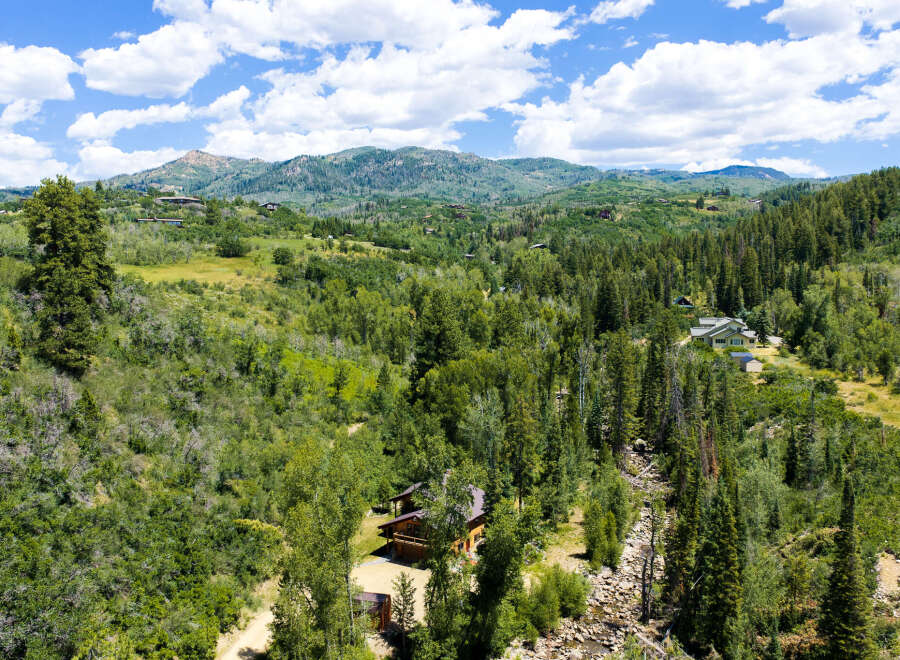 Nestled amidst a lush, verdant landscape, this property offers a serene mountain retreat.