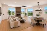 Experience breathtaking mountain views from this stunning living and dining area, featuring a modern sectional sofa, a cozy brick fireplace, and a stylish round dining table perfect for entertaining.