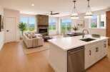Experience luxurious living in this stunning open-concept home, featuring a modern kitchen with a large island and sleek cabinetry, flowing seamlessly into a spacious living area with a cozy stone fireplace.