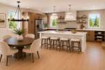 Experience modern living in this stunning kitchen featuring warm wood cabinetry, a spacious island with seating, and elegant pendant lighting.