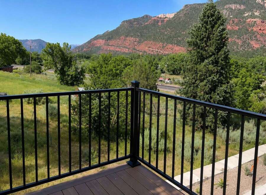 Enjoy breathtaking mountain views from this stunning property, featuring a spacious deck perfect for outdoor living.