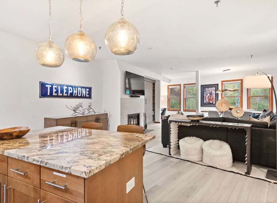 Experience modern living in this open-concept space, featuring a stunning granite island perfect for entertaining.