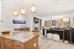 Experience modern living in this open-concept space, featuring a stunning granite island perfect for entertaining.