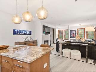 Experience modern living in this open-concept space, featuring a stunning granite island perfect for entertaining.