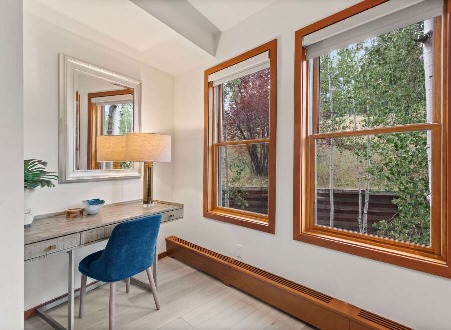 This charming room features a stylish vanity desk with a plush blue chair, perfect for getting ready.