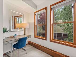 This charming room features a stylish vanity desk with a plush blue chair, perfect for getting ready.