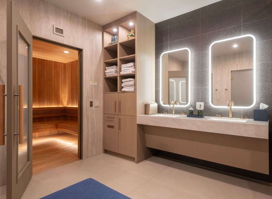 Experience ultimate relaxation in this luxurious spa area, featuring a traditional wood-paneled sauna with ambient lighting.