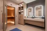 Experience ultimate relaxation in this luxurious spa area, featuring a traditional wood-paneled sauna with ambient lighting.