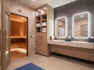 Experience ultimate relaxation in this luxurious spa area, featuring a traditional wood-paneled sauna with ambient lighting.