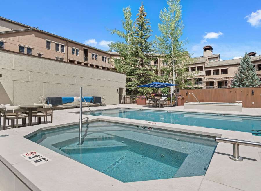 Enjoy a refreshing dip in this stunning outdoor pool and spa area, perfect for relaxation and entertainment.