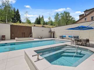 Experience luxury outdoor living with this stunning swimming pool and spa area, perfect for relaxation and entertainment.