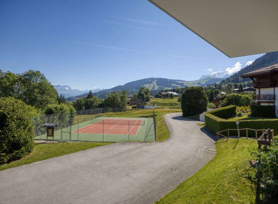 Enjoy a game of tennis with a stunning mountain backdrop at this property.