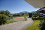 Enjoy a game of tennis with a stunning mountain backdrop at this property.