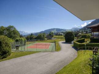 Enjoy a game of tennis with a stunning mountain backdrop at this property.