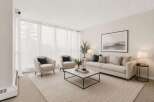 Step into this inviting living room, bathed in natural light from expansive sheer curtains.