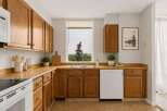 Discover this charming kitchen featuring warm oak cabinetry and durable laminate countertops.
