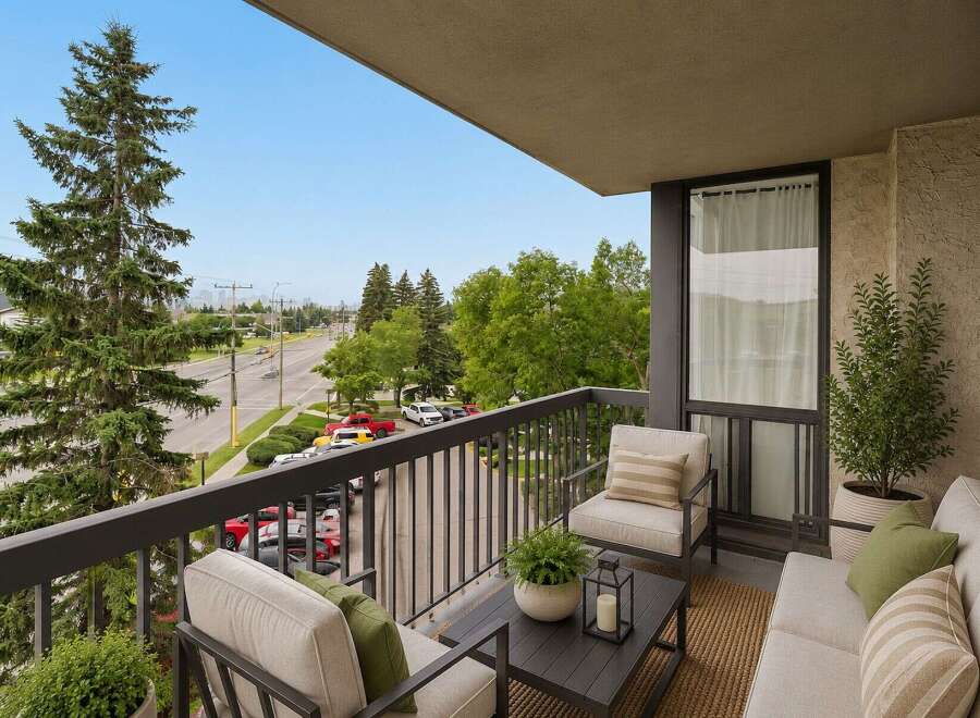 Enjoy your morning coffee or evening relaxation on this charming balcony, offering a serene outdoor living space with comfortable seating.