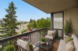 Enjoy your morning coffee or evening relaxation on this charming balcony, offering a serene outdoor living space with comfortable seating.