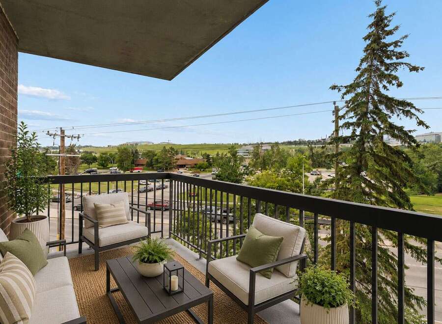 Enjoy your morning coffee or evening relaxation on this charming balcony, complete with comfortable seating and a coffee table.