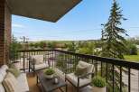 Enjoy your morning coffee or evening relaxation on this charming balcony, complete with comfortable seating and a coffee table.