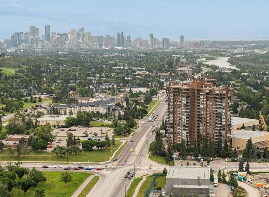 Experience city living with a touch of nature in this stunning high-rise apartment complex, offering breathtaking panoramic views of the city skyline and a lush, green landscape.